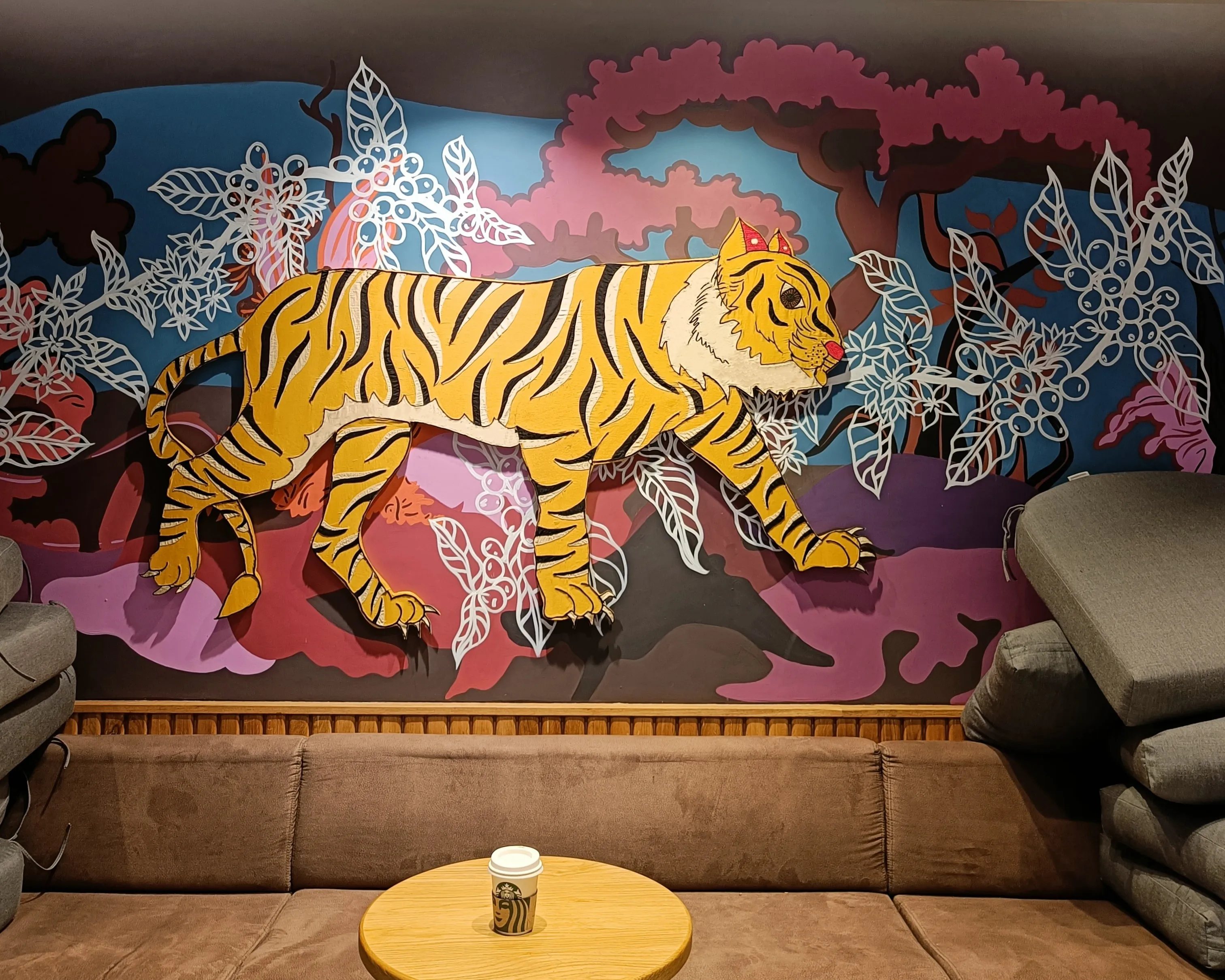 Detail of the coffee-jungle mural at Starbucks Indiranagar, Bengaluru
